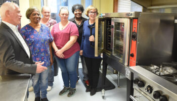 County Commission President Ed Hawkins talks with cooks and manager about the new equipment they got form funding form commission in photo left to right is Hawkins, Mary K. Layman, Kitchen food, Megan McDonald, Assistand Cook, Patricia Costello, Head Cook, Joy Thomas , Special Meals and Sara Bishop, manager Meals on Wheels.